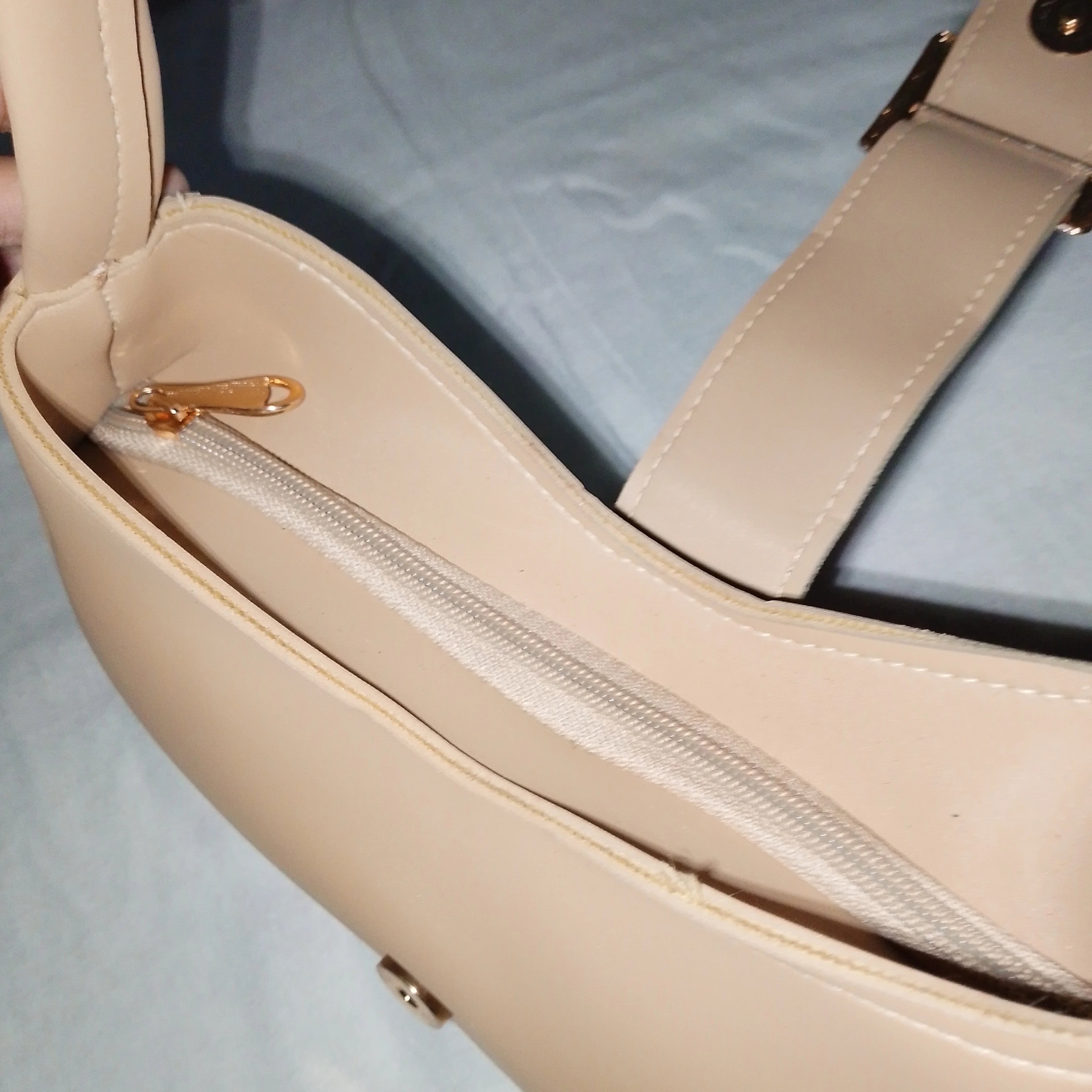 beige buckled handbag