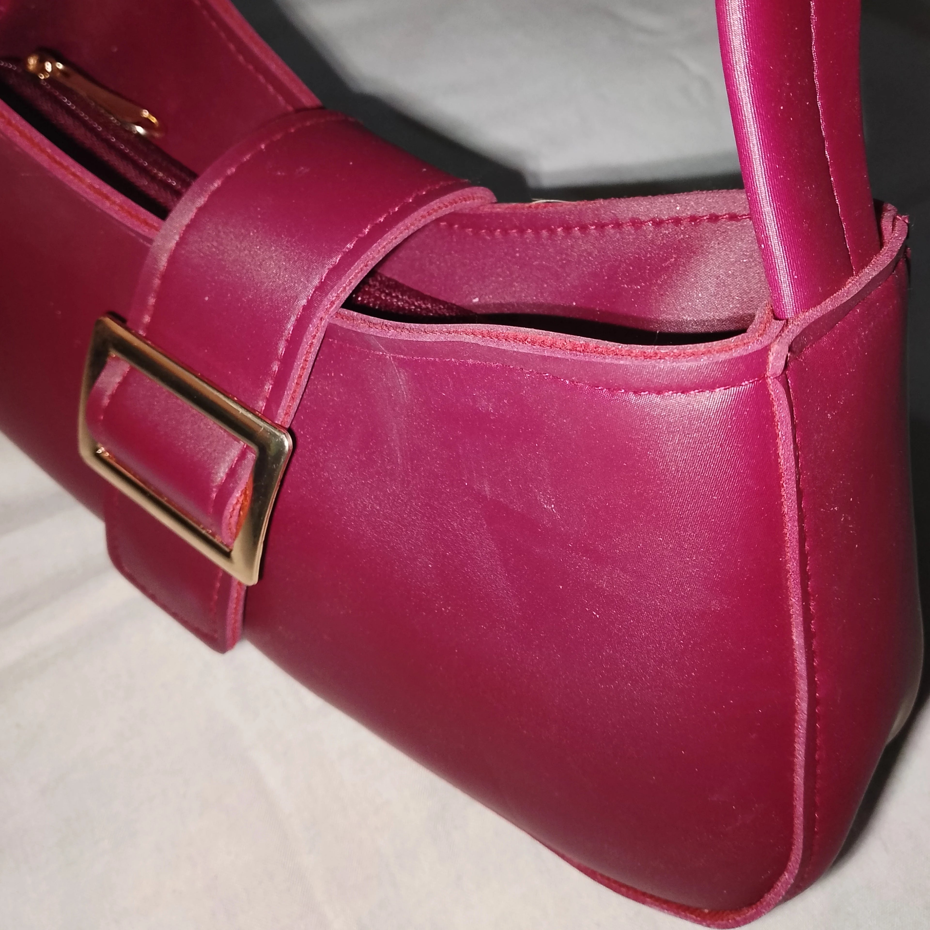 maroon buckled handbag