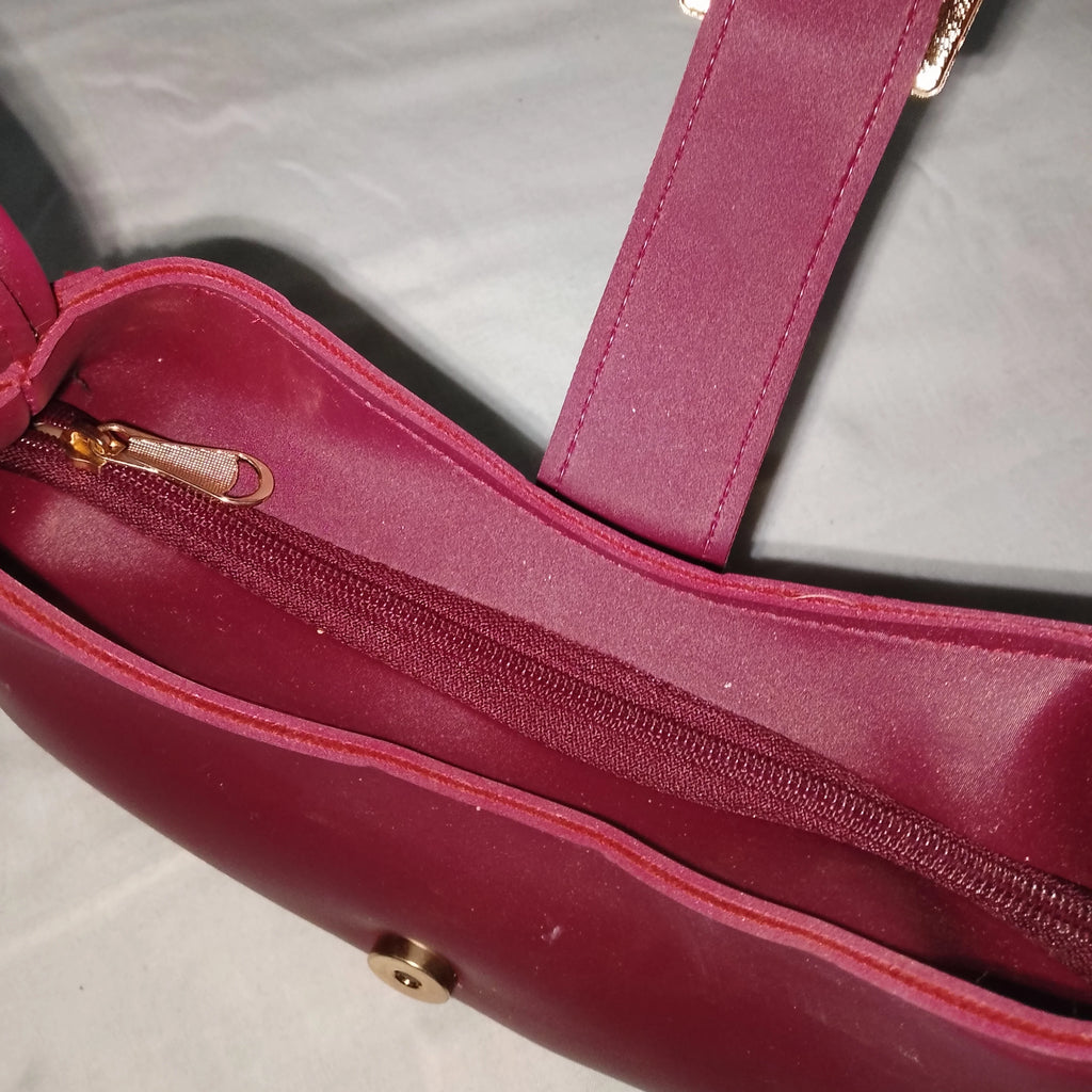 maroon buckled handbag