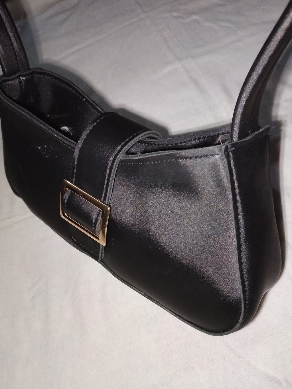 black buckled handbag