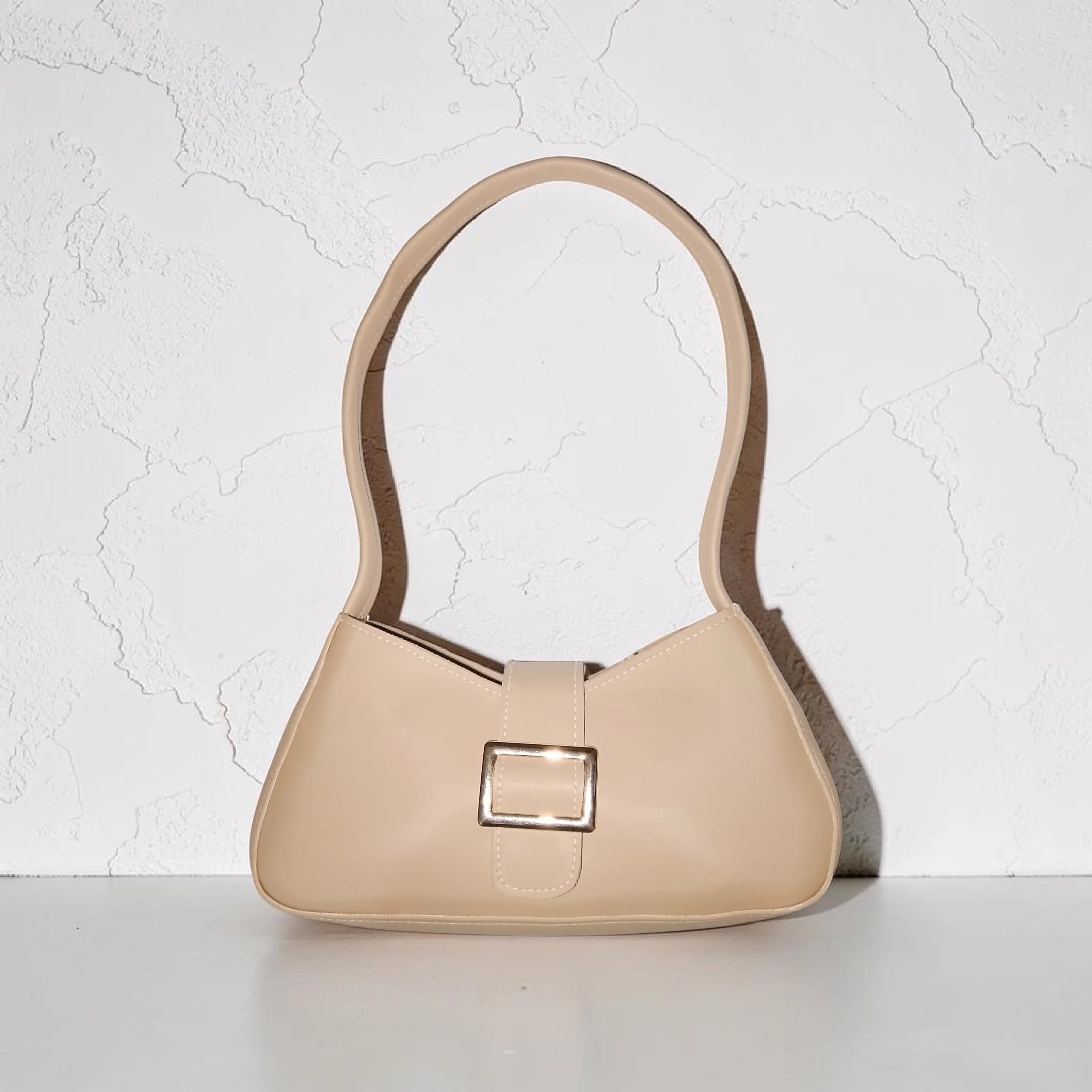 beige buckled handbag